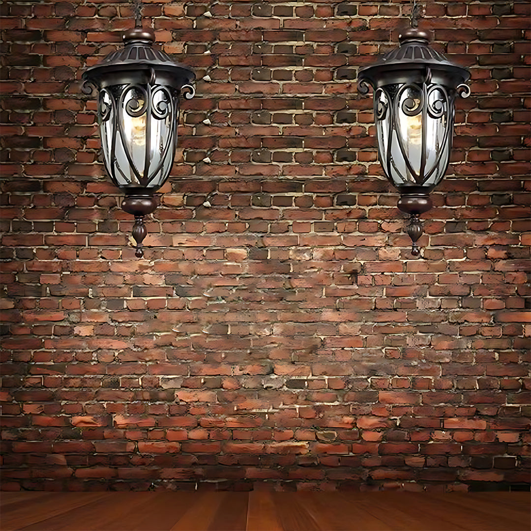 Two matching lanterns mounted on brick wall creating symmetrical outdoor lighting design