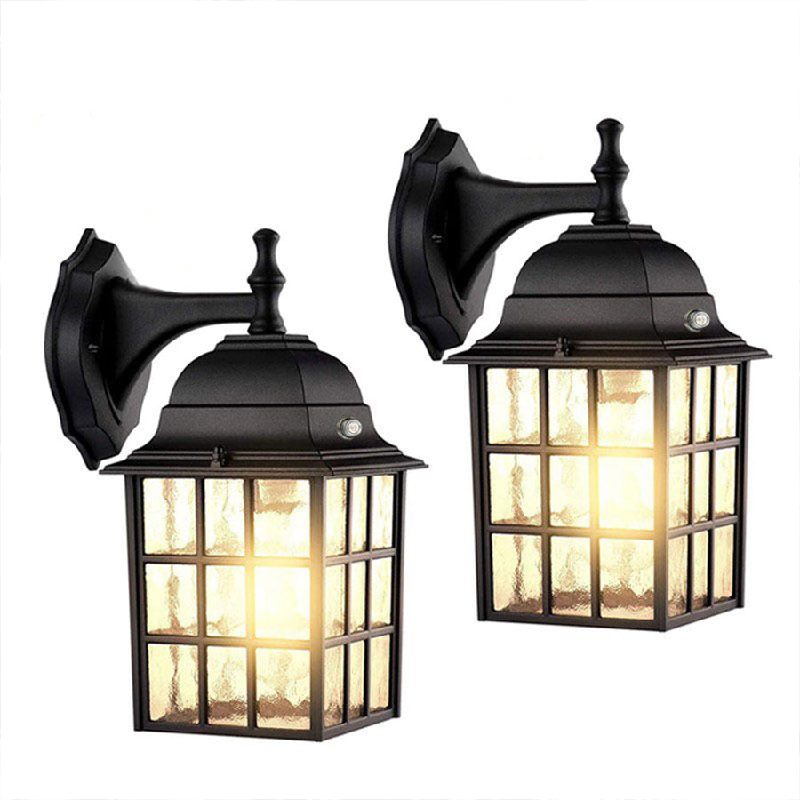 Pair of matching black lantern wall sconces with warm LED lighting and geometric glass panels