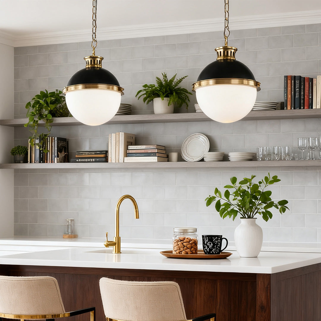 Two matching ball pendant light fixtures illuminating a light gray subway tile backsplash and open shelving over a kitchen counter.