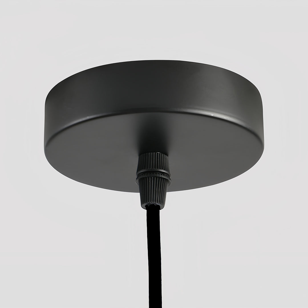 Close-up of a matte black ceiling canopy for a 1 light single pendant installation, highlighting the material finish.
