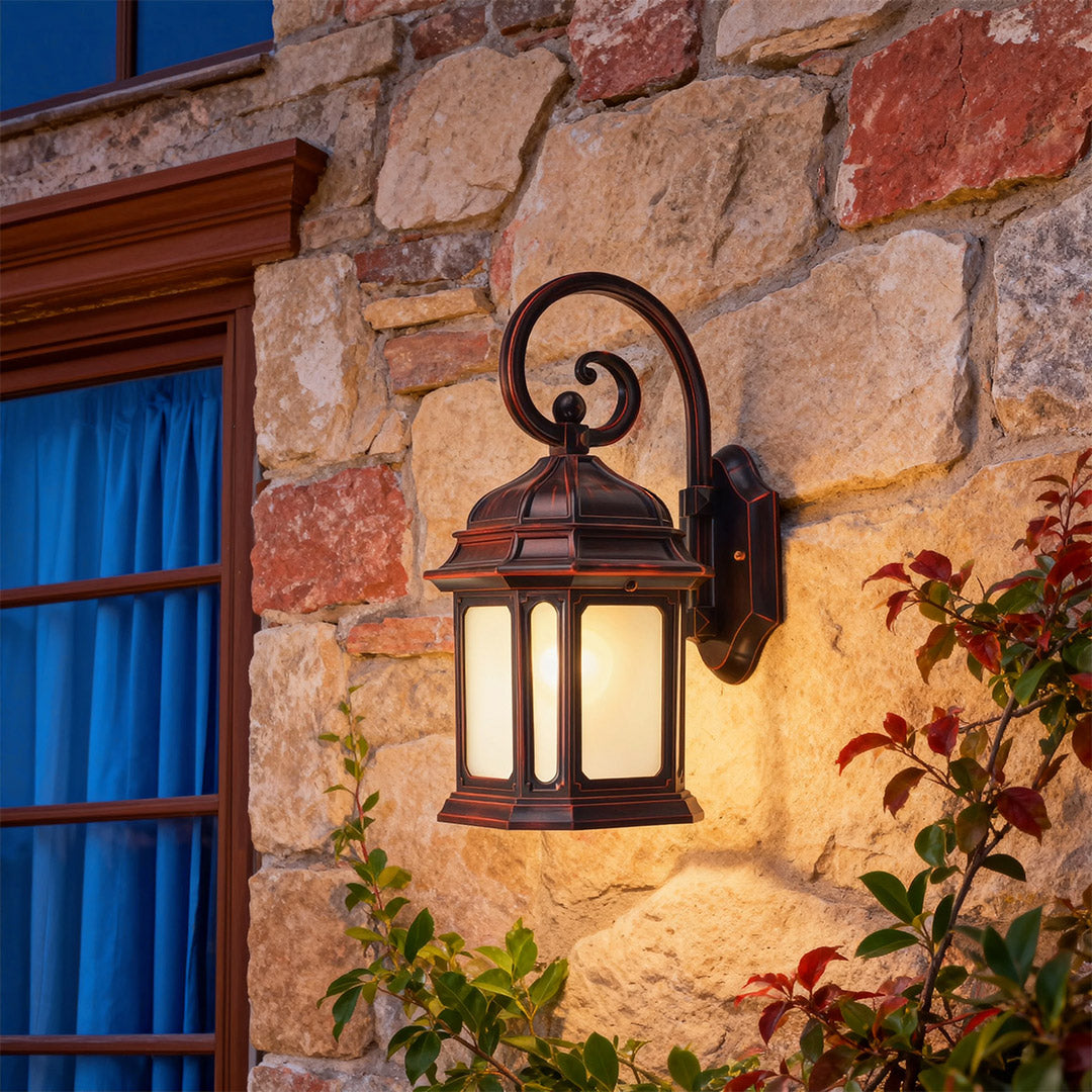 Mediterranean style exterior LED wall light glowing warmly on weathered stone wall with climbing vines