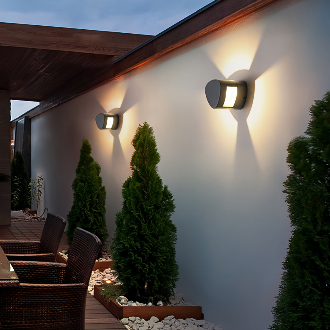 Classic wall light outdoor fixtures lighting a Mediterranean-style exterior walkway.