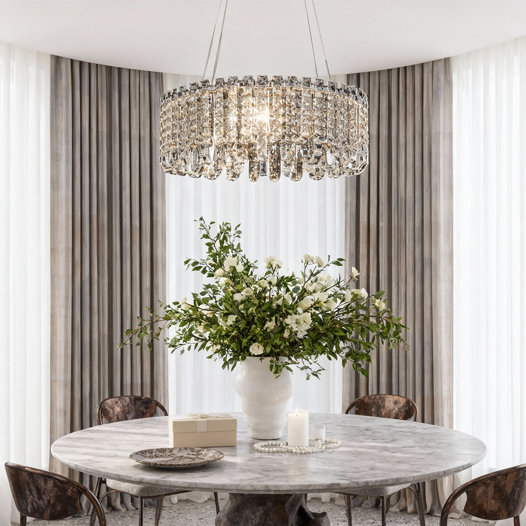 Luxury dining area featuring medium crystal chandelier modern with gold finish.