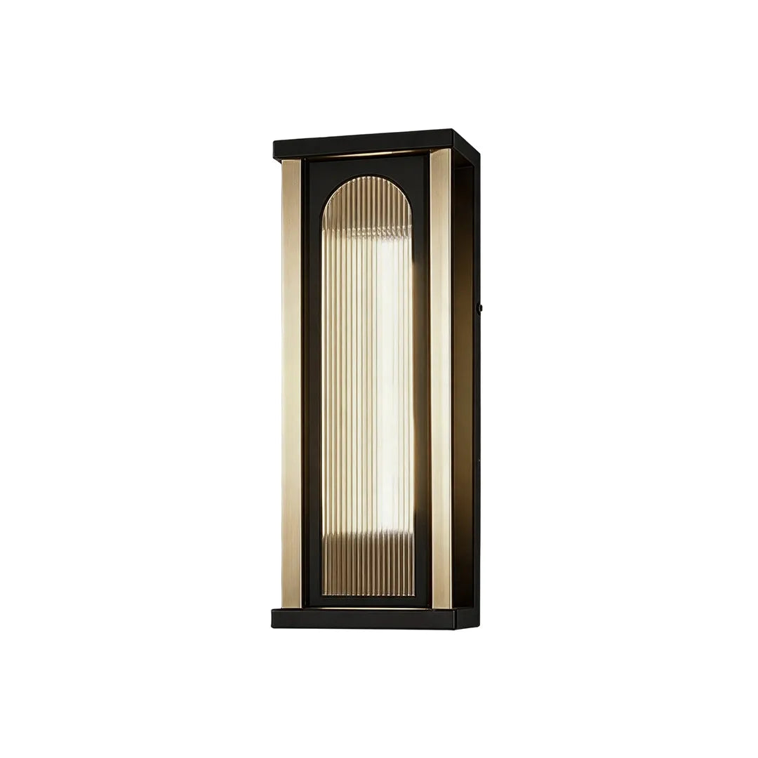 Medium outdoor wall sconce with black frame and warm ribbed glass shade