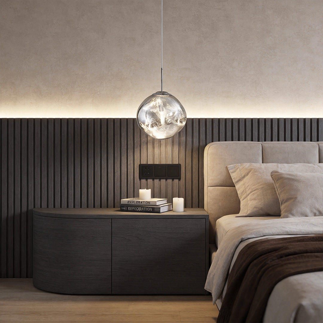 Melt LED pendant light hanging beside a modern bed, creating a soft reflective glow in a minimalist bedroom.