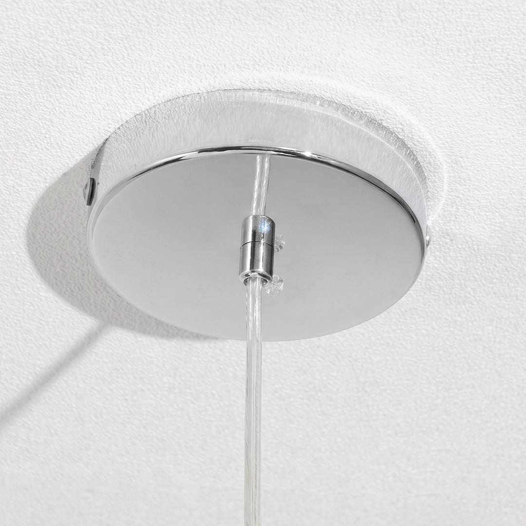 Close-up of the ceiling canopy and suspension wire of a melt LED pendant light.