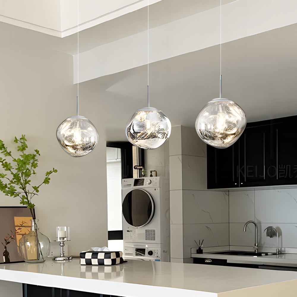 Cluster of melt LED pendant lights suspended over a contemporary kitchen counter for sculptural illumination.