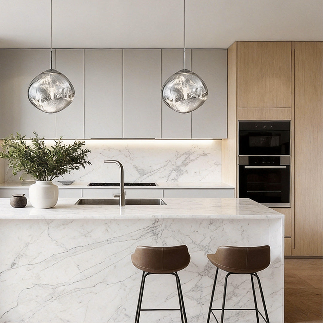 Melt LED pendant light installed above a kitchen island, adding artistic reflection and warm ambient lighting.