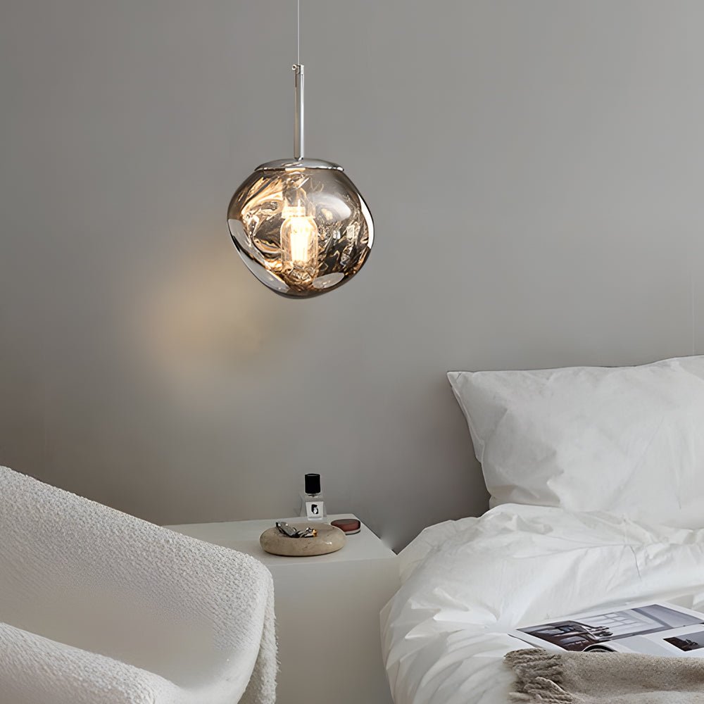 Side view of a melt LED pendant light against a neutral wall, emphasizing its organic mirrored surface.