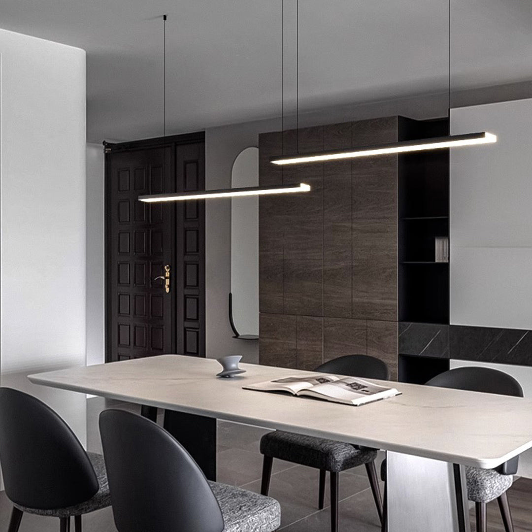 Small black pendant light with mesh texture creating ambient lighting in modern space