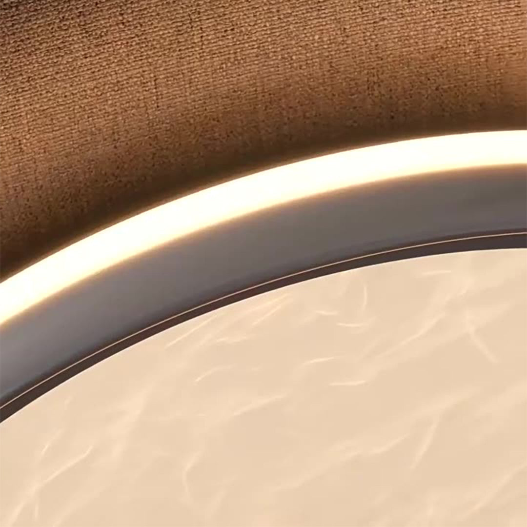 This silver-finished metal flush mount light combines minimalist design with white acrylic for bright, elegant, and durable ceiling lighting.