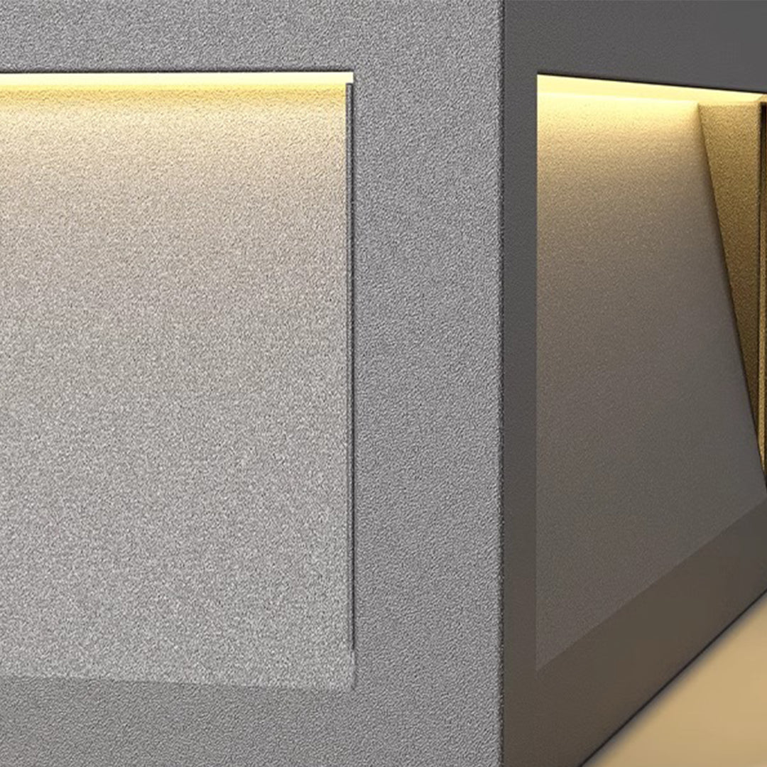 Metal pillar lights with a layered design, adding a contemporary touch to outdoor spaces.