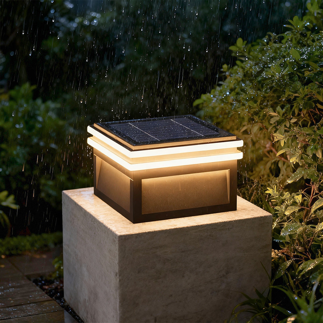 Metal pillar lights with a sleek design, illuminating a garden pathway with modern linear lighting.