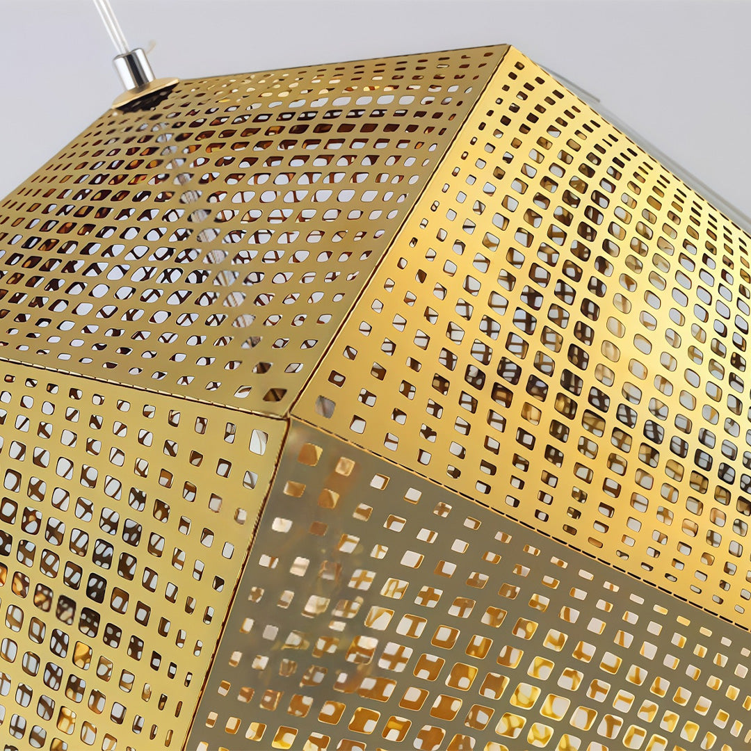 Gold-finished metal shade pendant light with perforated geometric panels displayed against a clean background.
