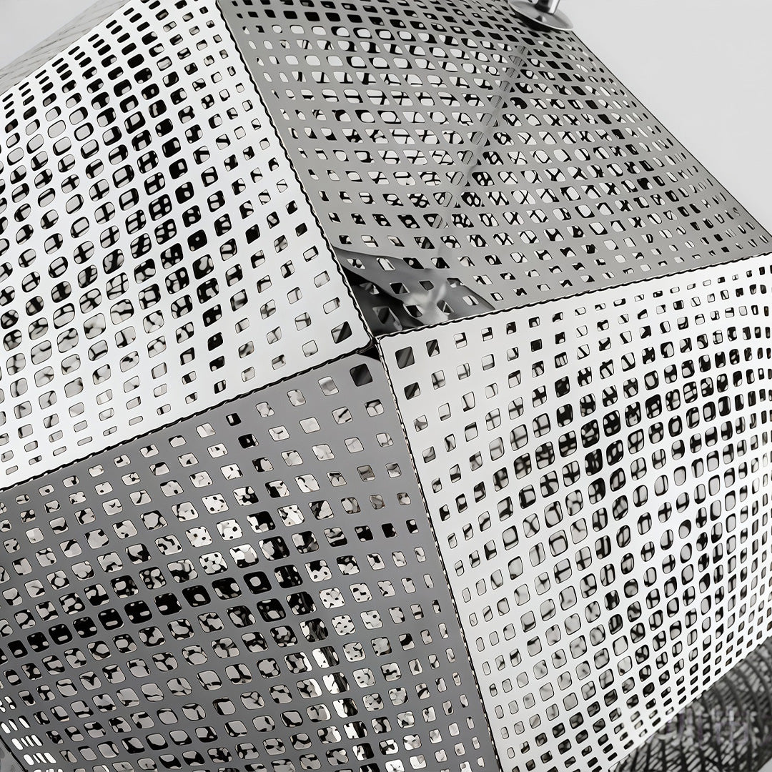 Detailed view of metal shade pendant light surface showing precision-cut perforations and geometric pattern.