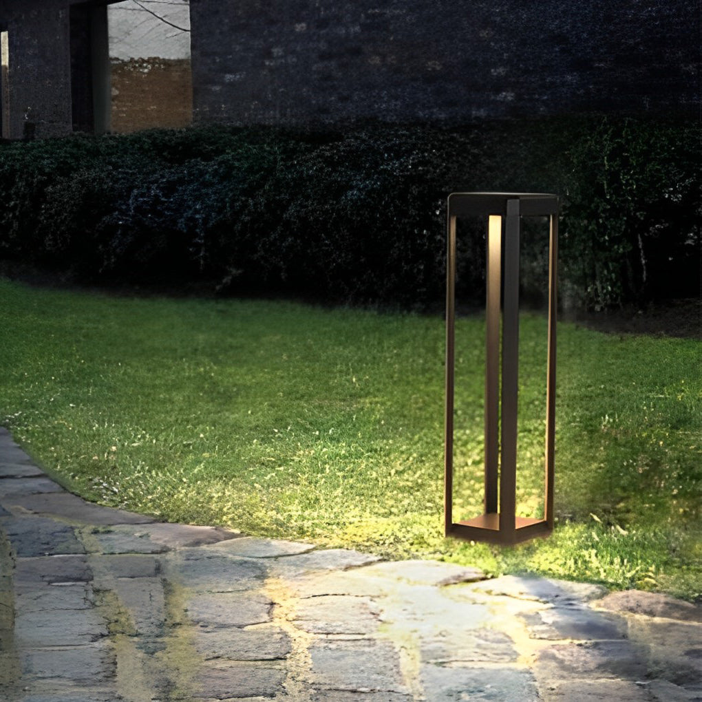 Metal solar pathway lights installed along a grassy path, enhancing the landscape with soft illumination.