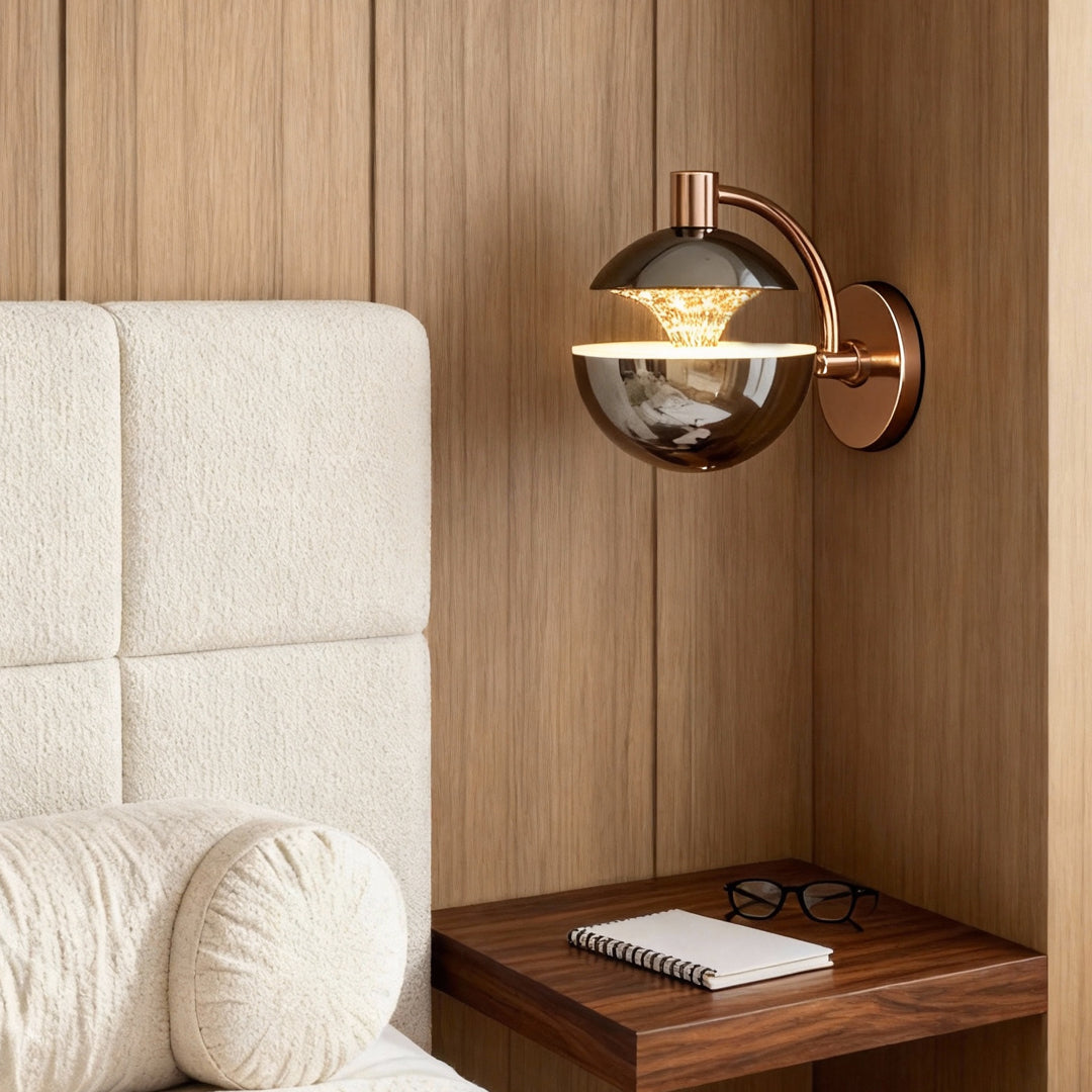 Metal wall sconce creating ambient lighting beside tufted headboard in warm-toned bedroom with natural wood architectural details