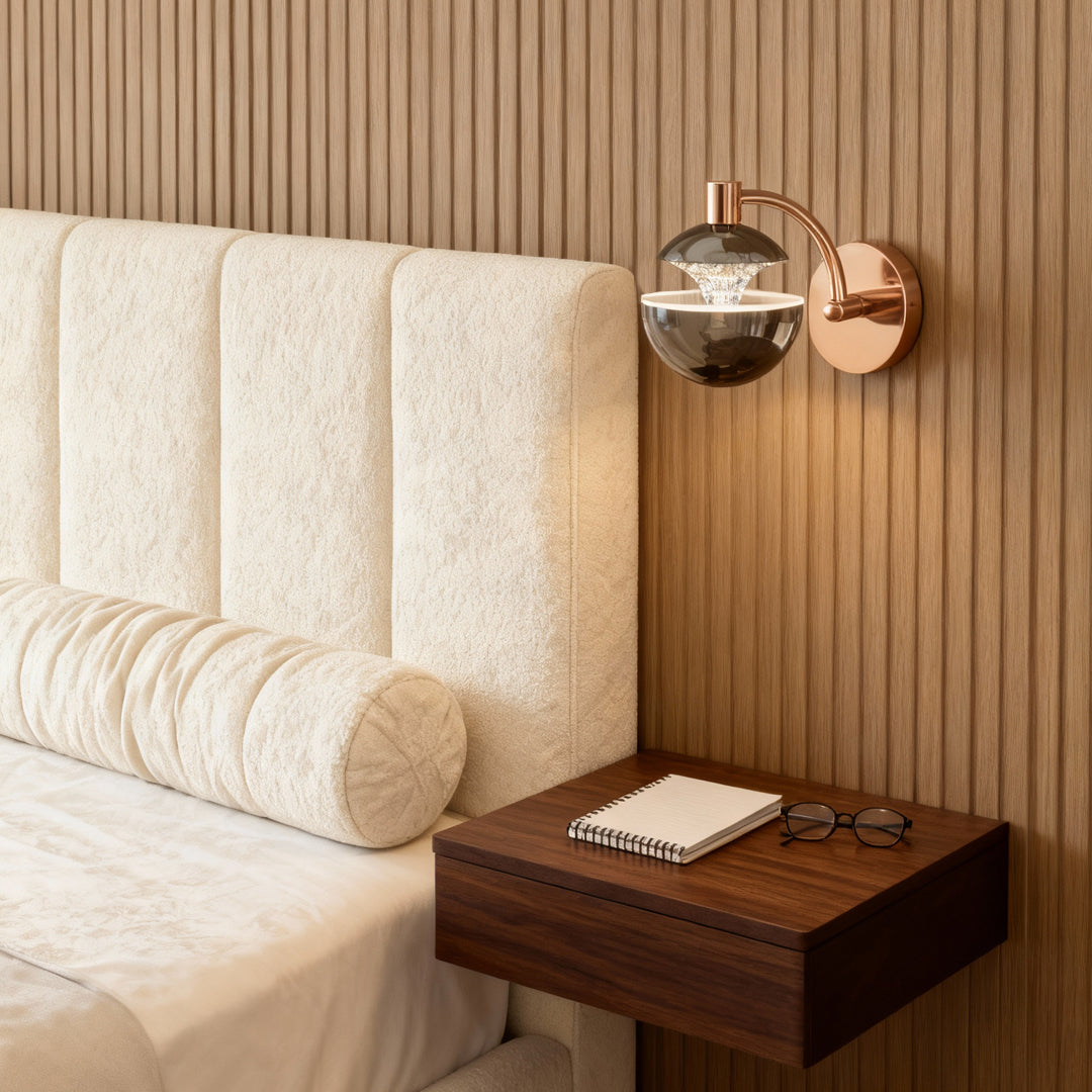 Metal wall sconce flanking bed in elegant bedroom with vertical wood slat accent wall and cream upholstered headboard