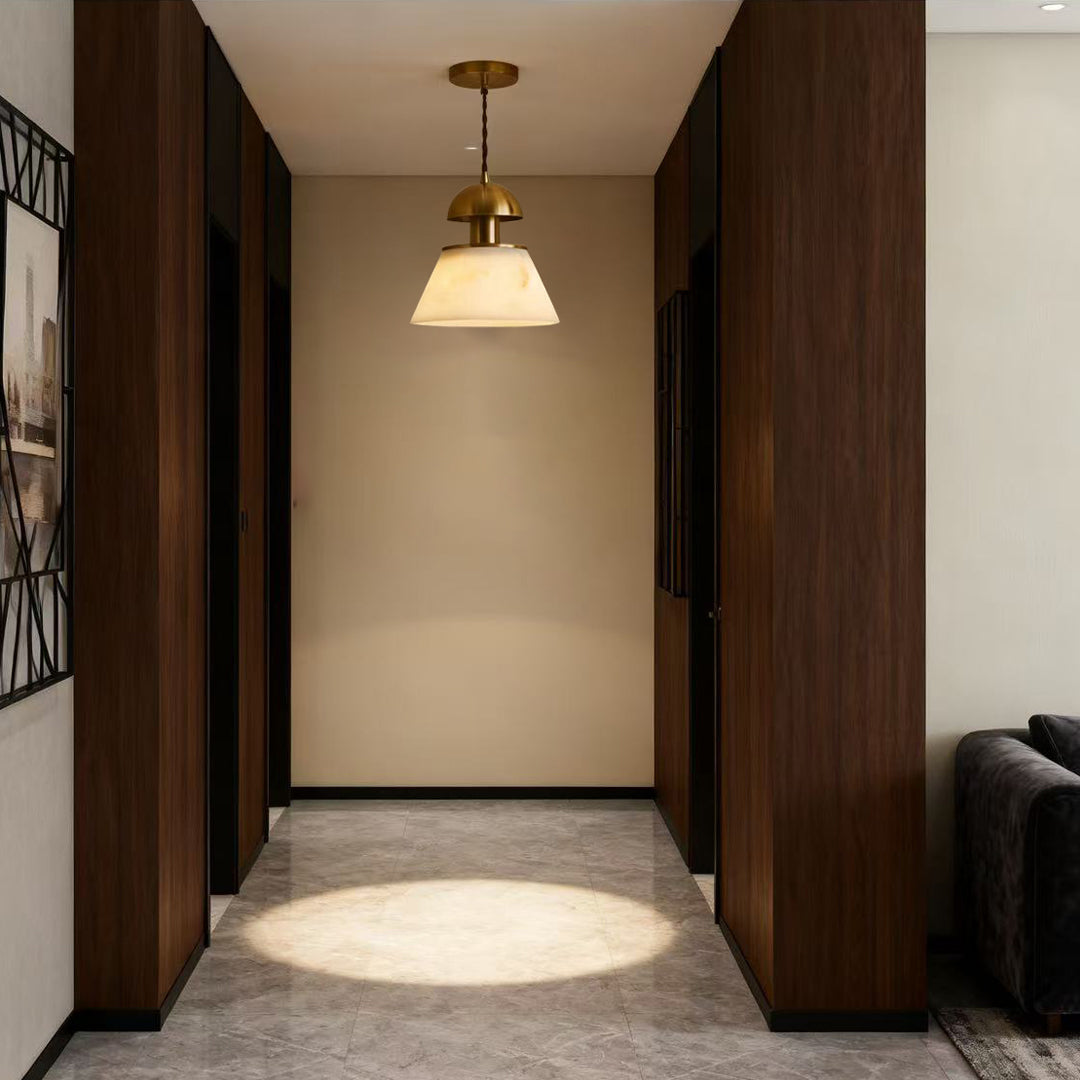 Metallic pendant lights providing ambient lighting in hallway with dark wood paneling and modern architectural details