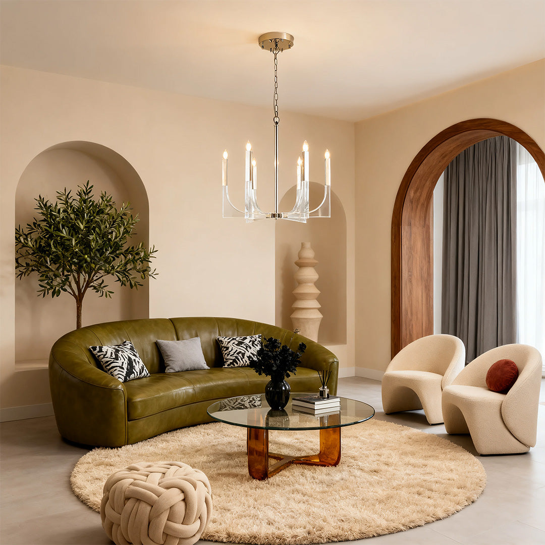 Mid-century retro chandeliers with chrome accents and curving arms, lighting a chic living room with a green leather sofa.