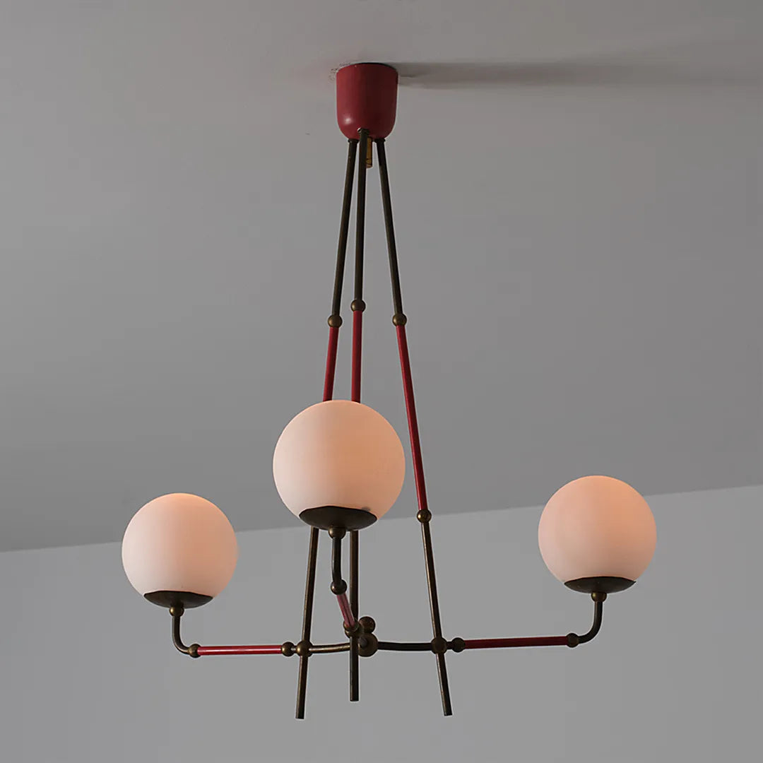 Mid century modern chandelier product image showing the lit fixture with three glowing globe shades.