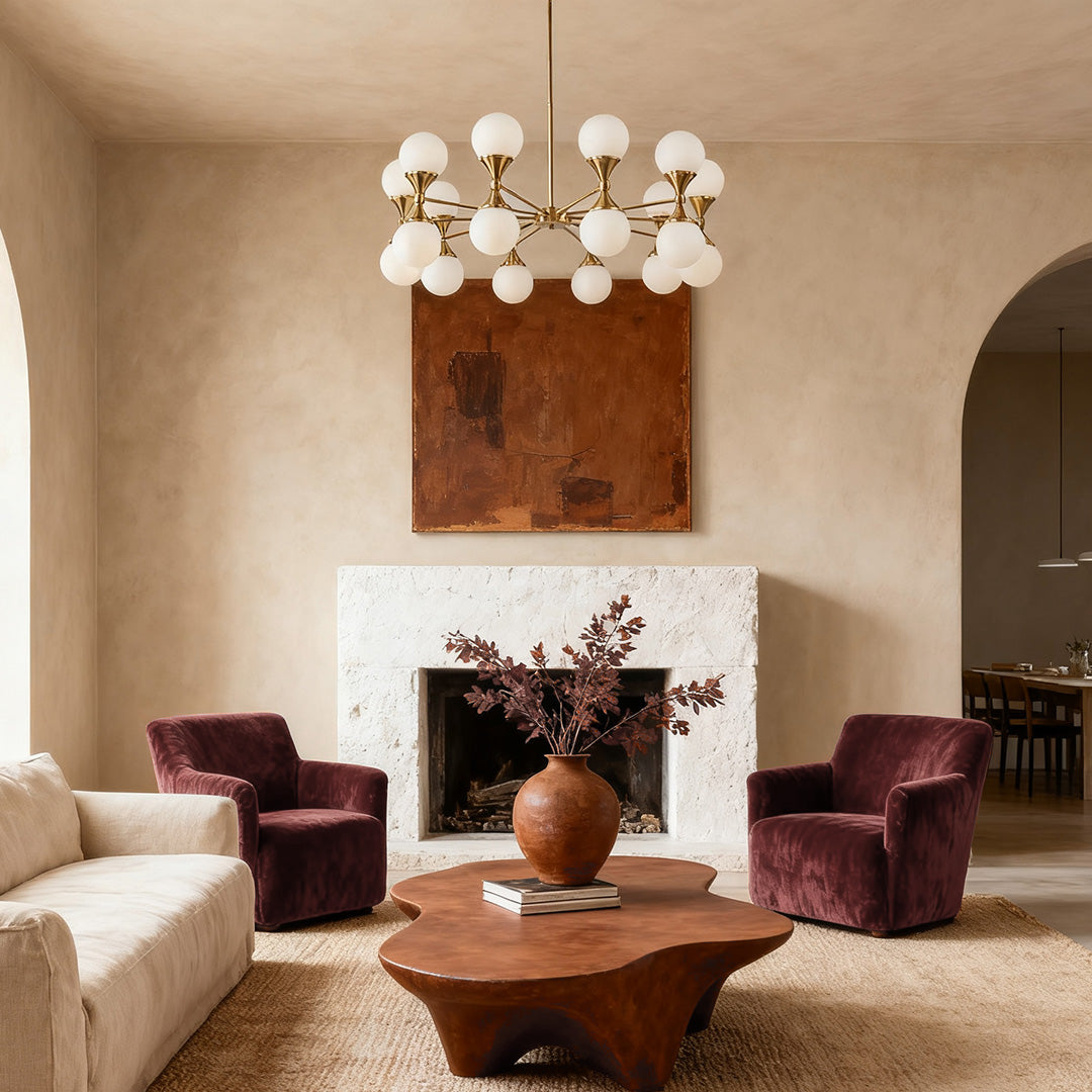 Mid-century modern bubble glass chandeliers with a warm gold finish, illuminating a marble dining table in a luxurious contemporary home.