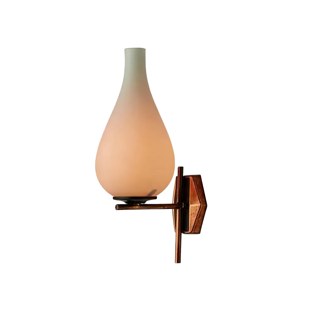 Mid century modern wall light isolated product view with a frosted glass shade and brass base.