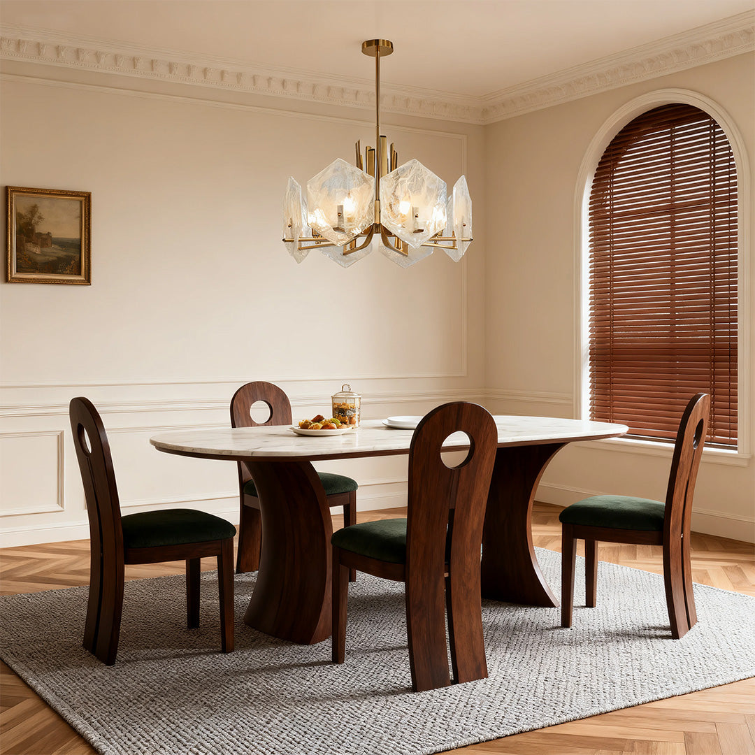 Mid-century modern dining space with a unique gold geometric chandelier providing ambient light over a sculptural wood table.