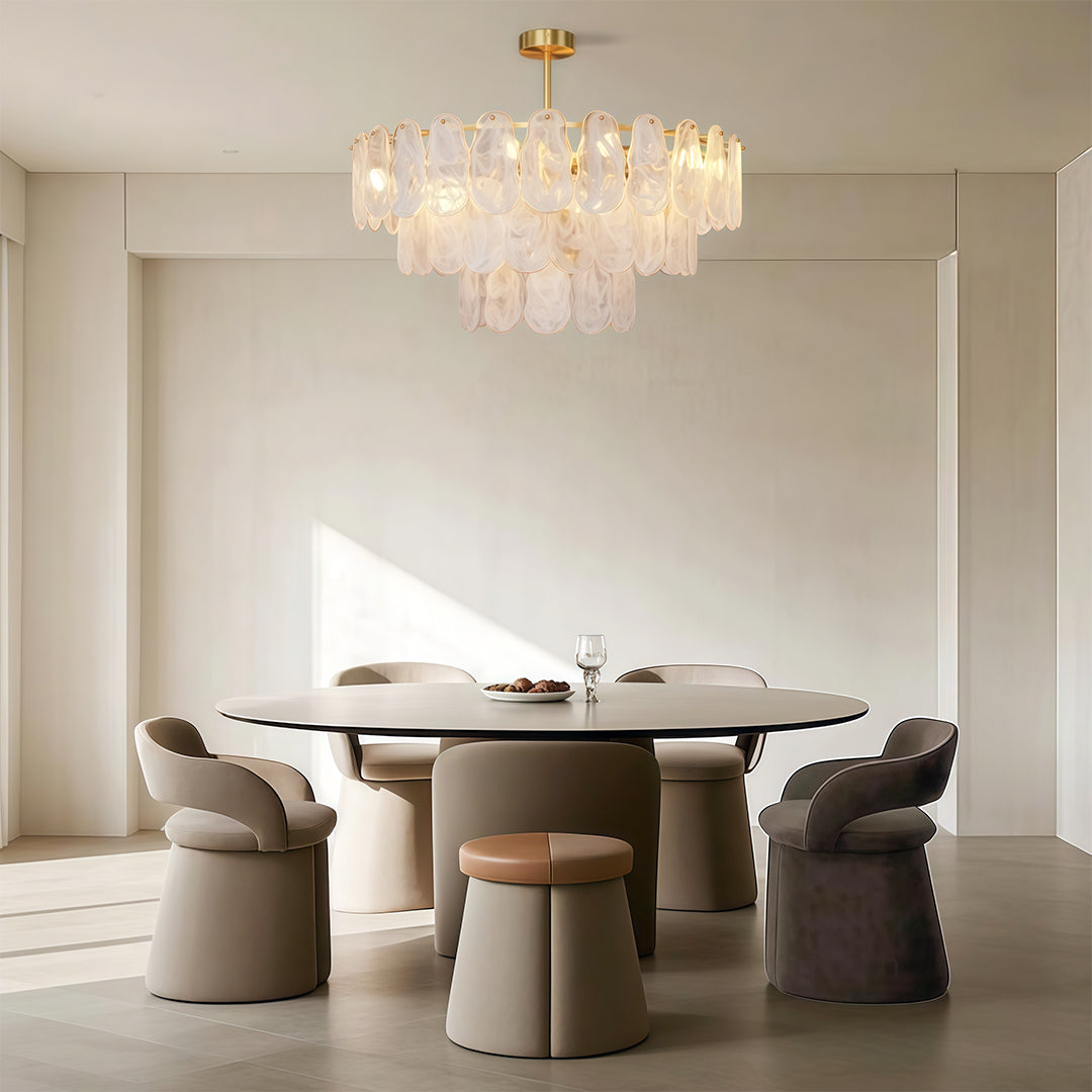 Luxury midcentury modern chandeliers enhancing bright kitchen dining area with white cabinetry and natural light.