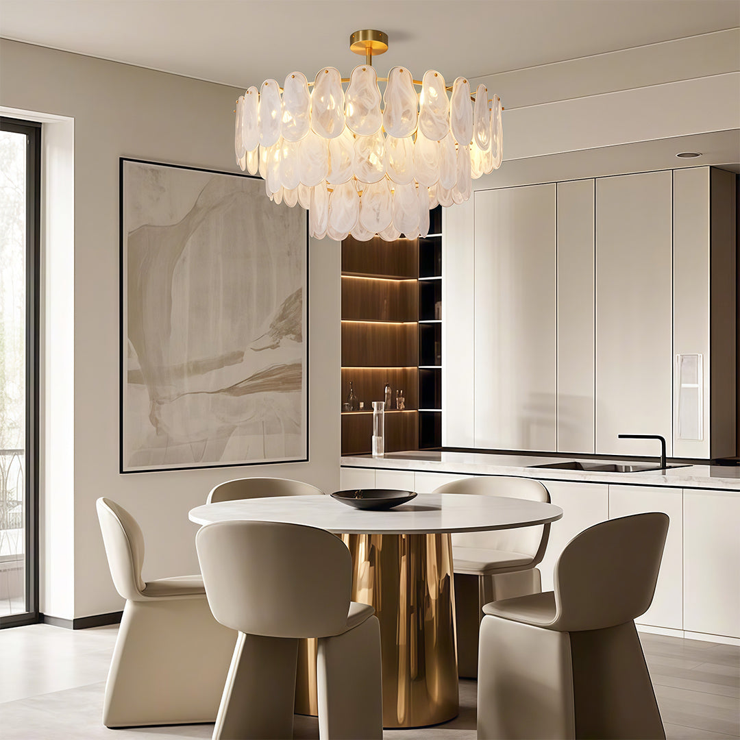 Midcentury modern chandelier close up highlighting brass frame and layered glass panel texture.