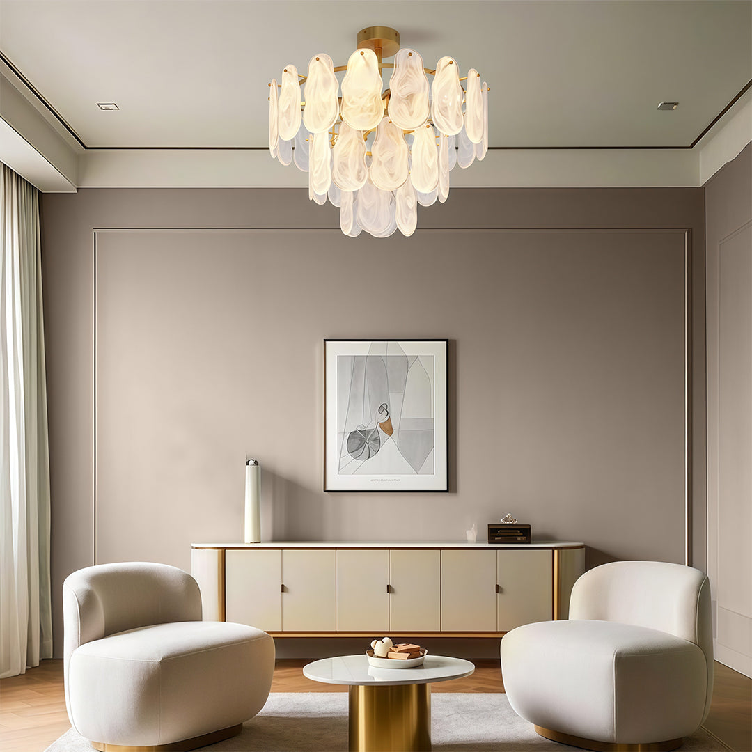 Luxury midcentury modern chandeliers lighting luxury dining room with marble surfaces and statement furniture.