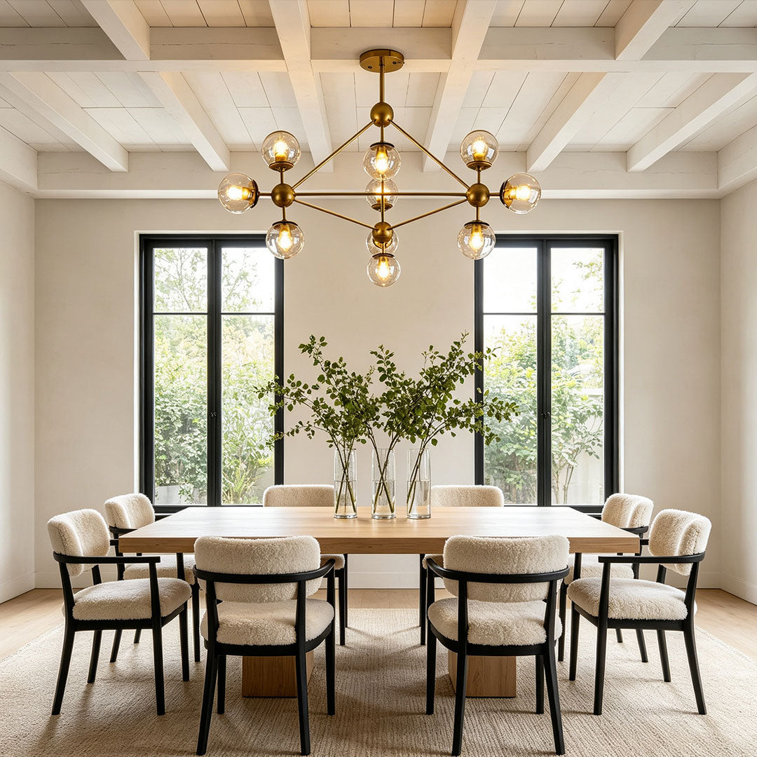 Midcentury modern chandeliers illuminating a bright dining area with contemporary interior decor.