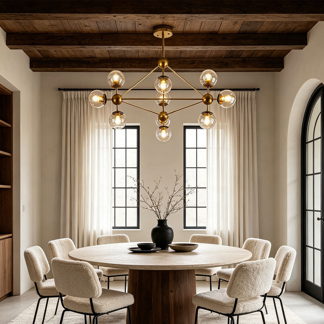 Midcentury modern chandeliers hanging above a dining table with rustic wood ceiling beams.