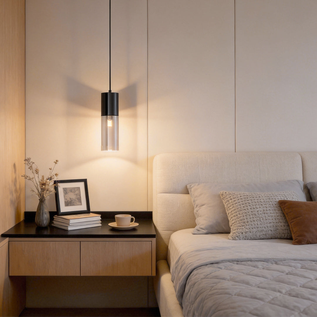 Mini black pendant light hanging beside a modern bedroom bed
