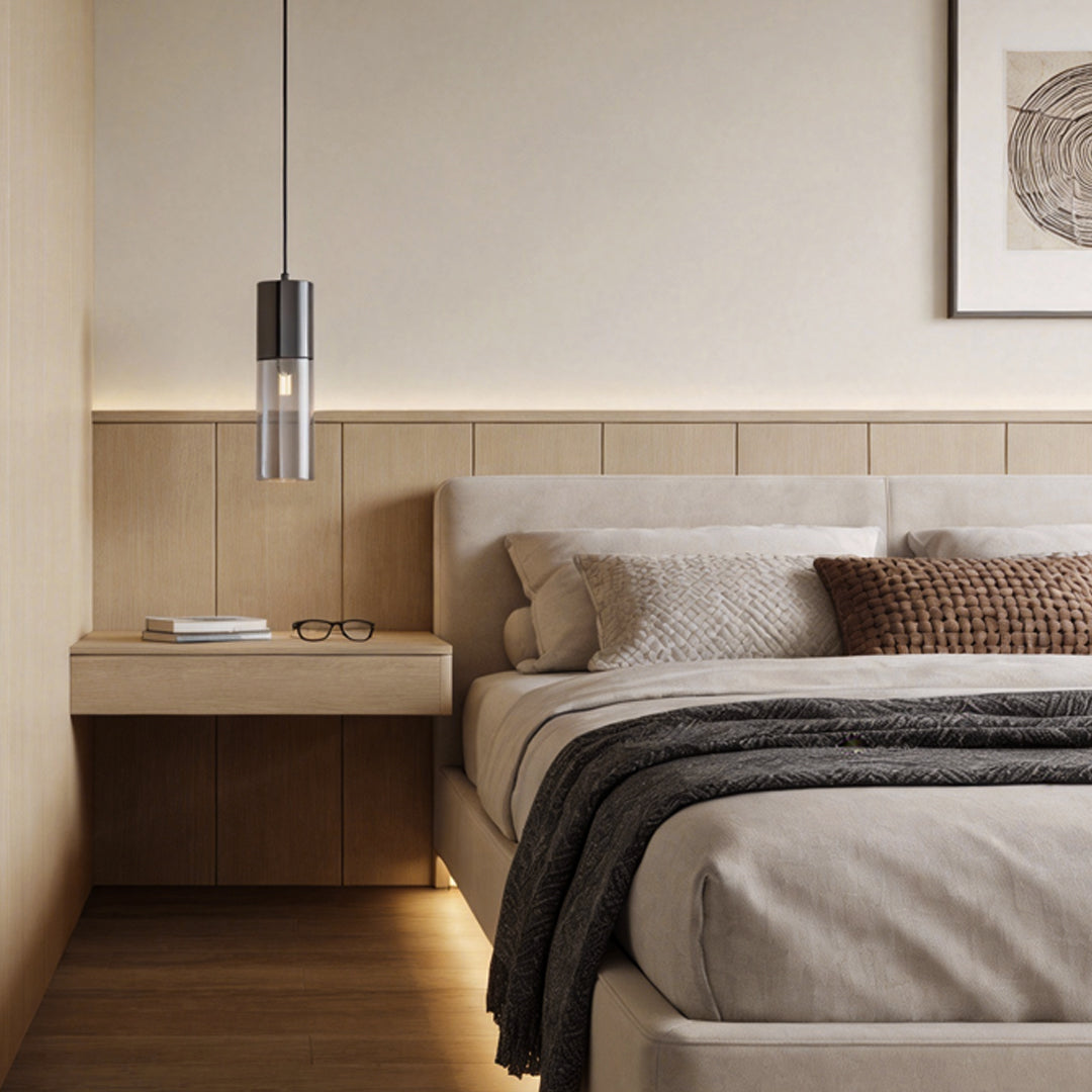 Mini black pendant light installed above a bedroom nightstand