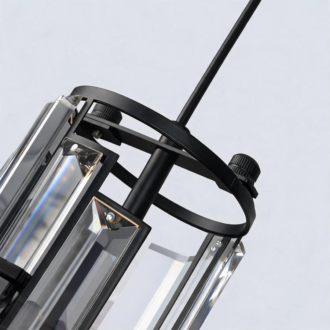 Close-up of a Mini Crystal Pendant Light with a black circular frame, clear crystal panels, and hanging cord.