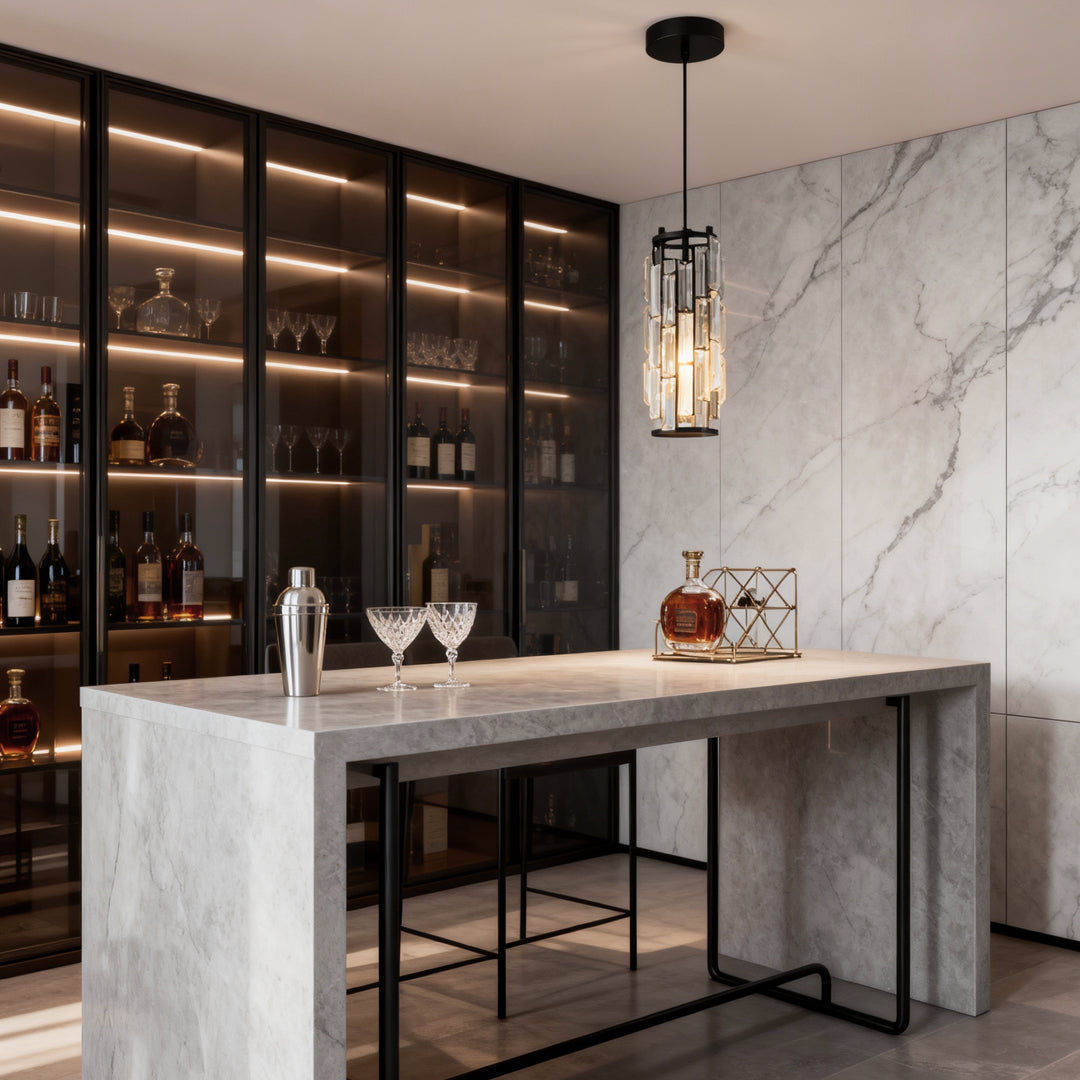 Single mini crystal pendant light above a marble bar counter in a luxury interior.