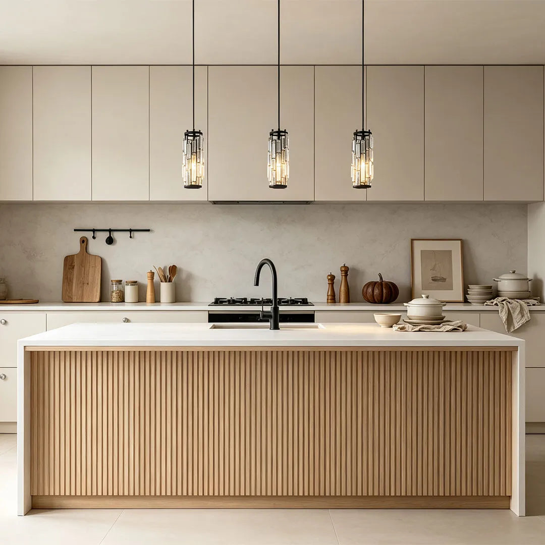 Mini crystal pendant light trio in a dark finish hanging above a modern white kitchen island.