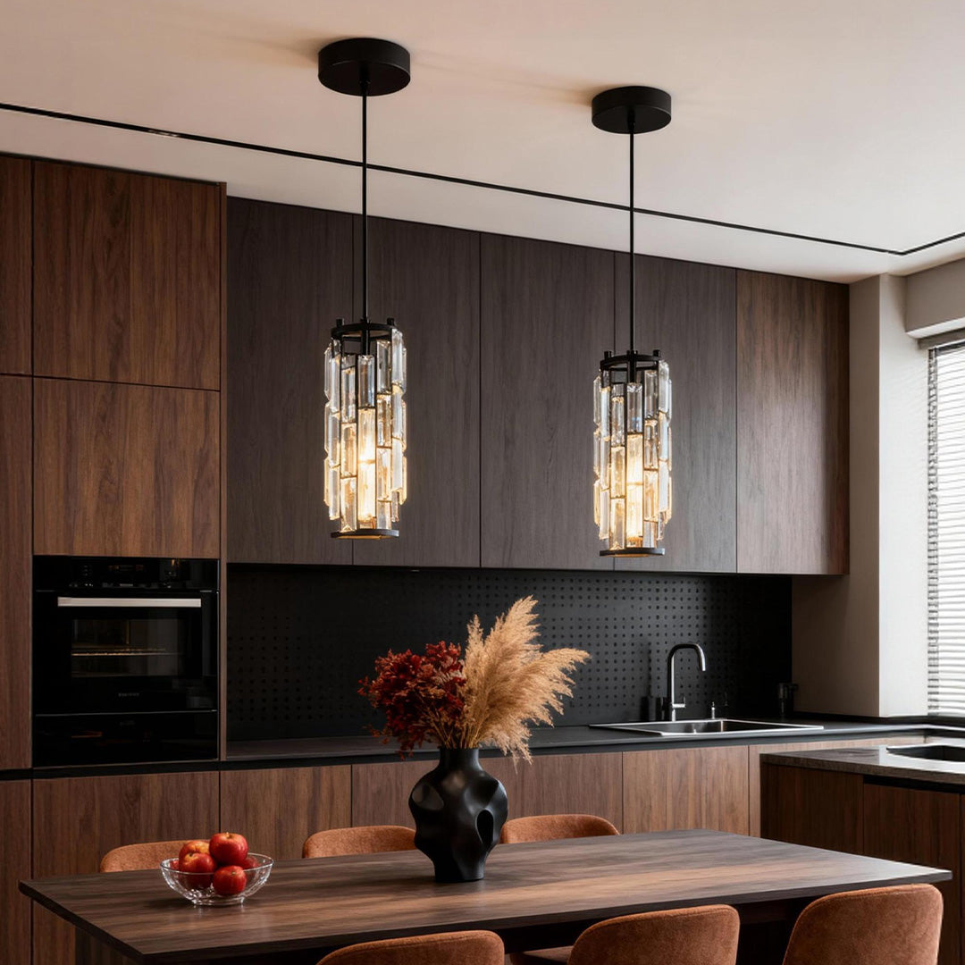 Mini crystal pendant lights installed above a modern kitchen island with dark wood cabinetry.