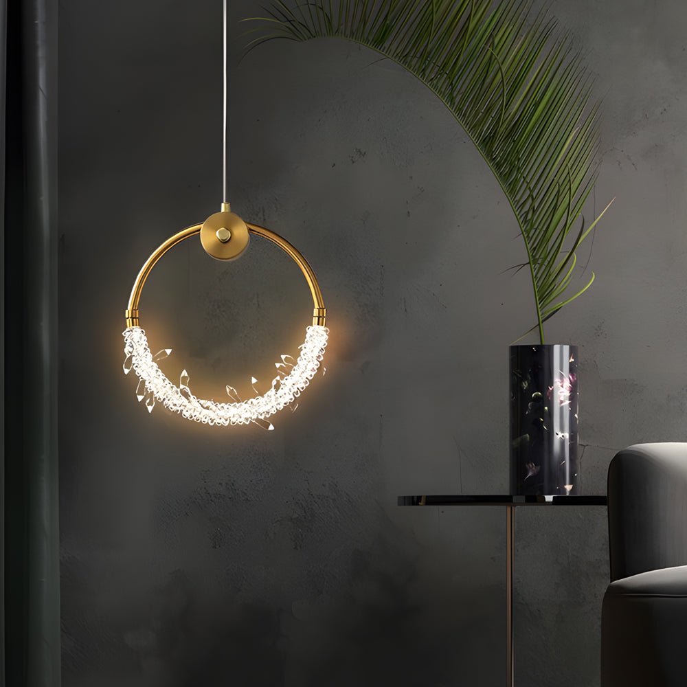 Mini crystal ring pendant light with a sleek design, providing ambient lighting in a contemporary room.