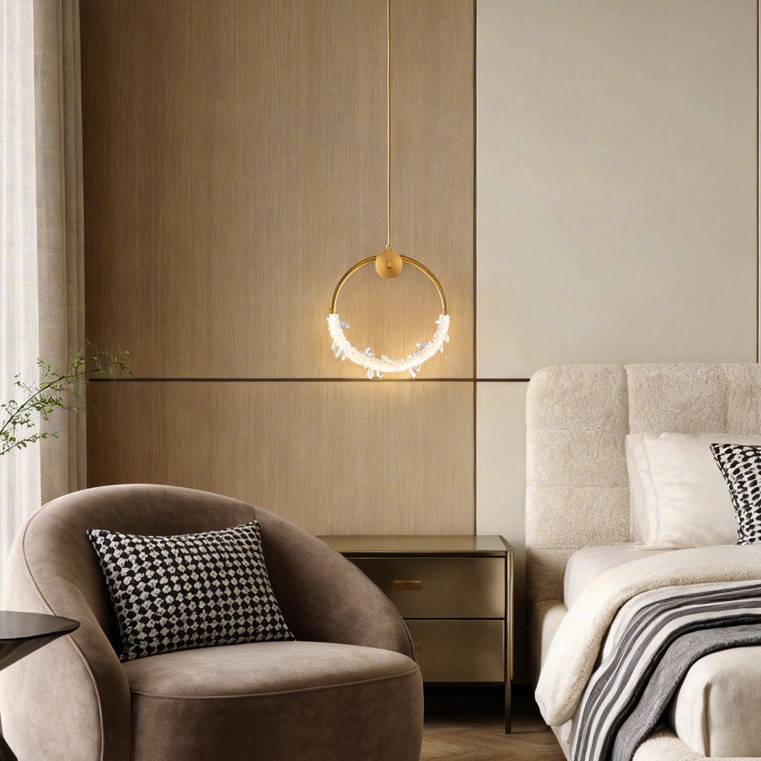 Mini crystal ring pendant light with sparkling crystals, illuminating a cozy bedroom corner.