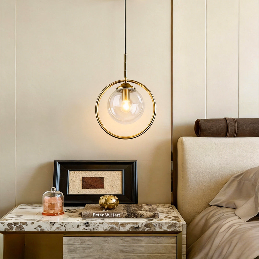 Mini gold pendant light illuminating a modern bedroom with warm, ambient glow.