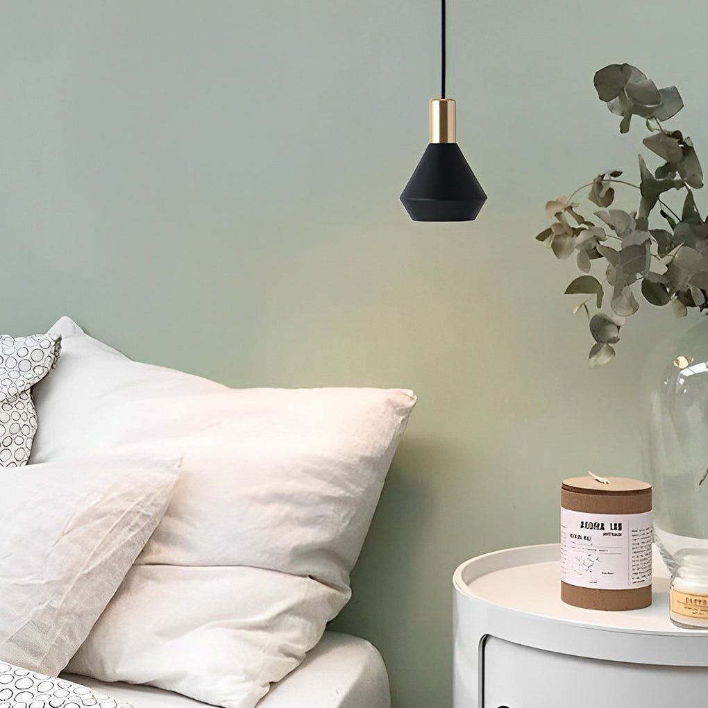 Mini hanging pendant lights suspended beside a bed, adding soft accent lighting and contemporary style to a calm bedroom setting.