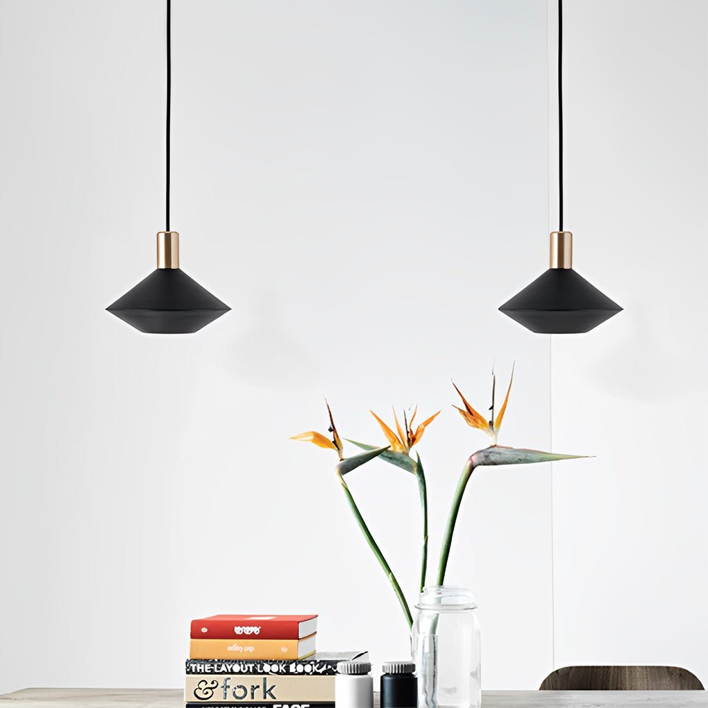 Mini hanging pendant lights displayed above a dining table with decorative flowers, creating a clean Scandinavian-style interior.