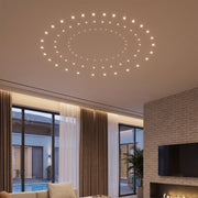 Mini LED spotlight arranged in circular patterns on a modern living room ceiling.