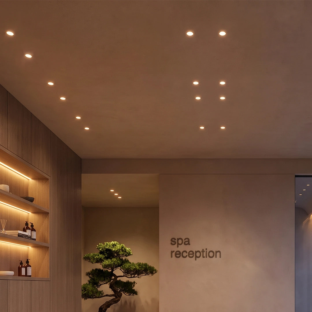 Mini LED spotlight installed above a spa reception area with warm wood accents.