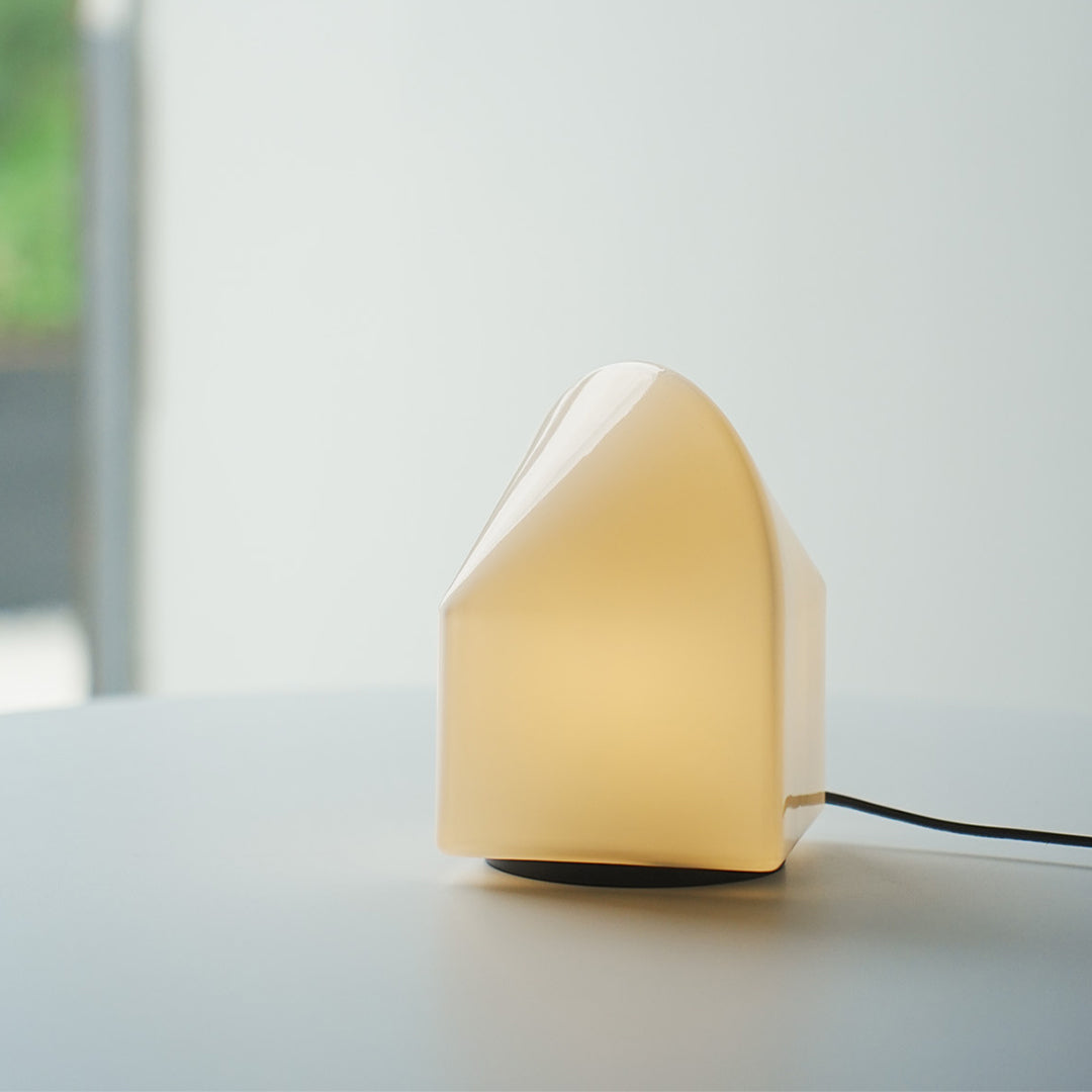 Minimal house modern white table lamp with slanted top design, simple modern lighting decor.