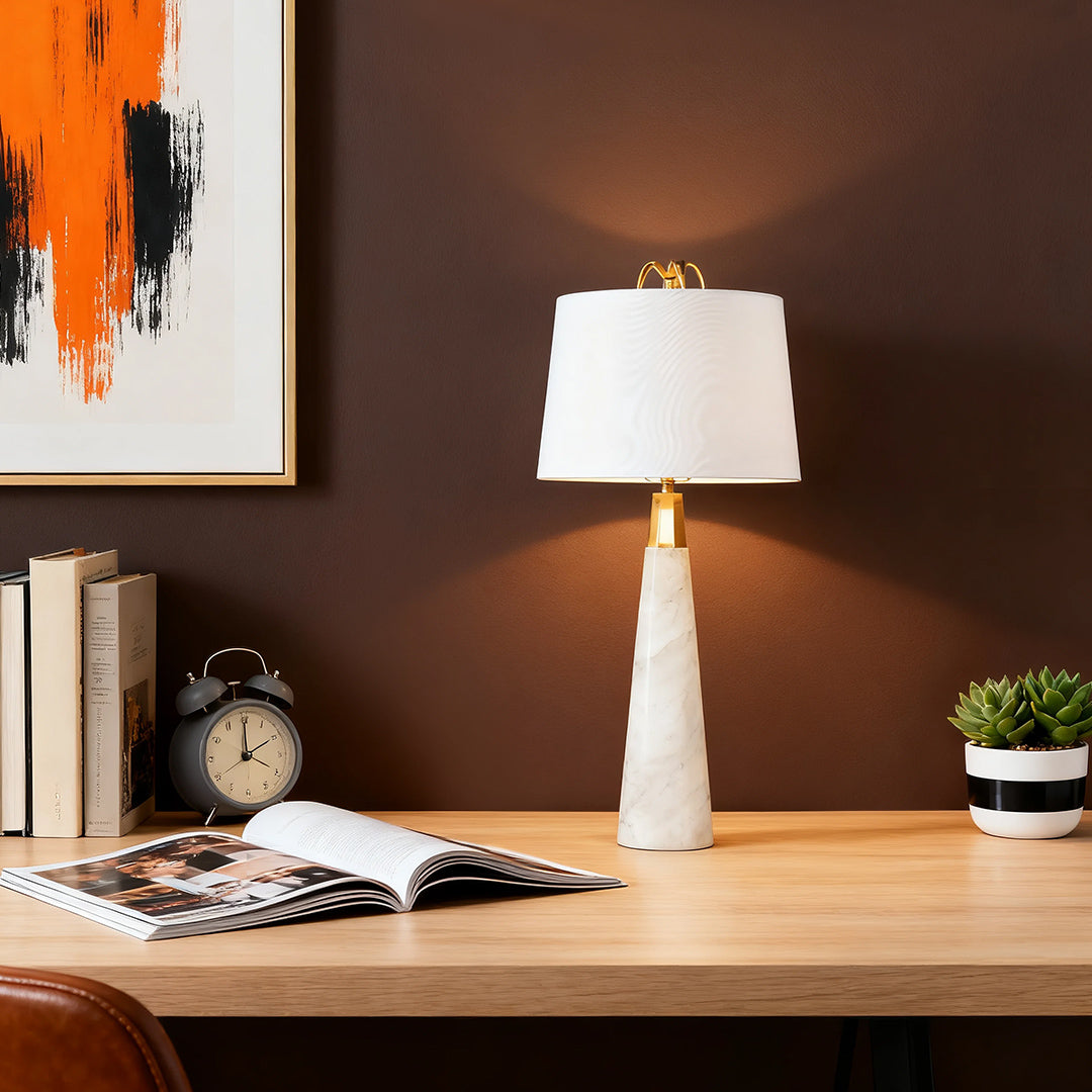White marble table lamp with beige lampshade in a stylish home office