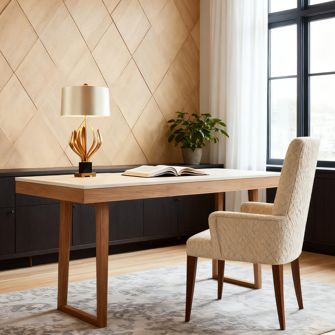 Stylish gold metal table lamp with sculptural base and beige lampshade in a modern home office