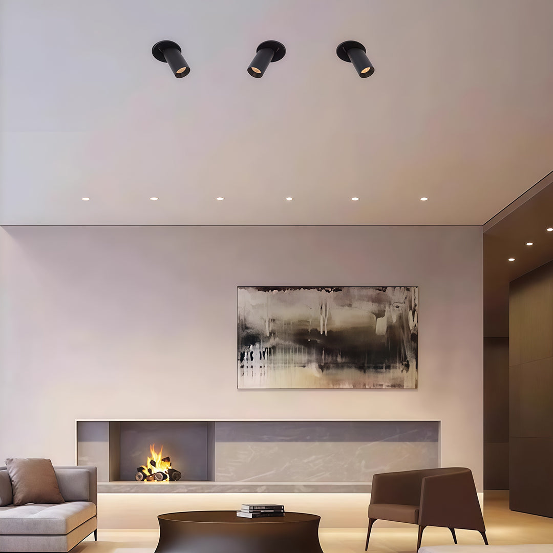 Minimalist adjustable LED ceiling spotlights with glass shade chandelier influence creating focused accent lighting in contemporary space.